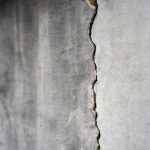 Old,foundation,and,plaster,wall,with,cracks.,building,requiring,repair